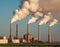 Industrial landscape with smokestack and smoking chimneys.