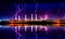 Industrial landscape with smoking chimneys and reflection in water at night