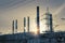 Industrial landscape. Sunset over the power line and pipes of combined heat and power plant