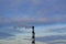 Industrial large chimney against the sky