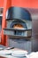 Industrial large oven for a bakery or restaurant with an open fire, a huge metal stove