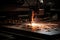 Industrial laser cutting automotive part with sparks flying in the air. laser CNC machine cutting off a metal plate in a