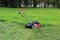 industrial lawn mower at work in early summer. the process of cutting the grass