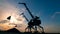 Industrial loaders are discharging gravel at sunset