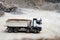 Industrial machinery details - dumper trucks waiting for loading at quarry and construction site