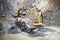 Industrial machinery and heavy duty excavators working at rock quarry