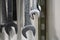 Industrial macro shot of metal wrenches hanging on wall