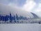 Industrial metal hangar blue in winter under snow