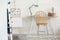 Industrial mint colored lamp on stylish wooden desk in white kid`s bedroom