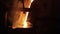 Industrial molten steel pouring in foundry. Metal casting process in manufacturing plant, fiery orange glow from furnace