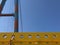 Industrial motiv with giant crane and steel constructions a deep blue sky with copy space for text. Strong blue and yellow colors