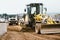 Industrial motor grader working at highway construction site