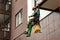 Industrial mountaineering worker during high rise work