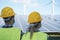 Industrial people working at solar power station while wearing safety masks - Focus on woman head