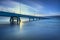 Industrial pier on the sea. Side view. Long exposure photography