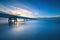 Industrial pier on the sea. Side view. Long exposure photography