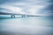 Industrial pier on the sea. Side view. Long exposure photography.