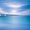 Industrial pier on the sea. Side view. Long exposure photography.