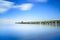 Industrial pier on the sea. Side view. Long exposure photography.