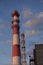 Industrial pipe over the factory on the background of the autumn sky. Chimney, boiler room pipe