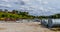 Industrial pipe storage lot under a sky filled with white puffy