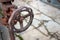 Industrial pipeline and valve close up, blur concrete background. Old rusty control equipment, abandoned plant industry with