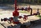 Industrial piping with steel flanges and bolts on oil field. Fuel pipes valves and crude pipelines. Gas drilling derricks at