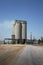 Industrial plant on a sky background. A huge building and a smokestack of a dairy factory. Ecology concept. Copy space.