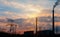 Industrial power plant with smokestack during sunset.