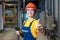 Industrial production. A female engineer in uniform and a protective helmet, holding a tablet in her hands, gives a thumbs up. The