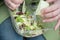 Industrial salad with sauce and plastic fork in plast