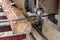 Industrial sawing of logs using sawmill equipment.