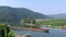 Industrial ship driving along moselle river with its vineyard landscape in Germany