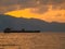 Industrial ships sail in the middle of the ocean in the afternoon.