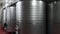 Industrial stainless steel vats in modern brewery.