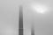 Industrial towers covered in fog