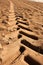 Industrial tractor footprint on beach sand