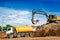 Industrial truck loader excavator and bulldozer moving earth