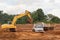 Industrial truck loader excavator moving earth and unloading int