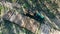 Industrial truck is unloading sawn woods in a view from above. Forest, tree logging, aerial view.