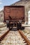 Industrial view of the back of a brown vagon covered with rust.