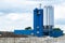 Industrial view of a blue factory buildings, concrete plant with silos and a chute.