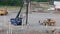 Industrial view on construction site. Pile driving machine driving piles into ground site.