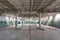 Industrial warehouse with cement walls, floors, windows and pillars before construction, remodeling, renovation