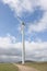 Industrial wind turbines on a rural property with a gravel road