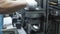 Industrial worker assembling electrical motor on robotic equipment at factory