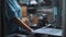 Industrial worker assembling metal appliances at automatical conveyor at factory