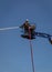 Industrial worker on a basket of a boom arm wetting debris