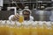 Industrial worker examining bottle in factory