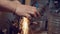 Industrial worker grinding metal detail on lathe at metallurgical plant